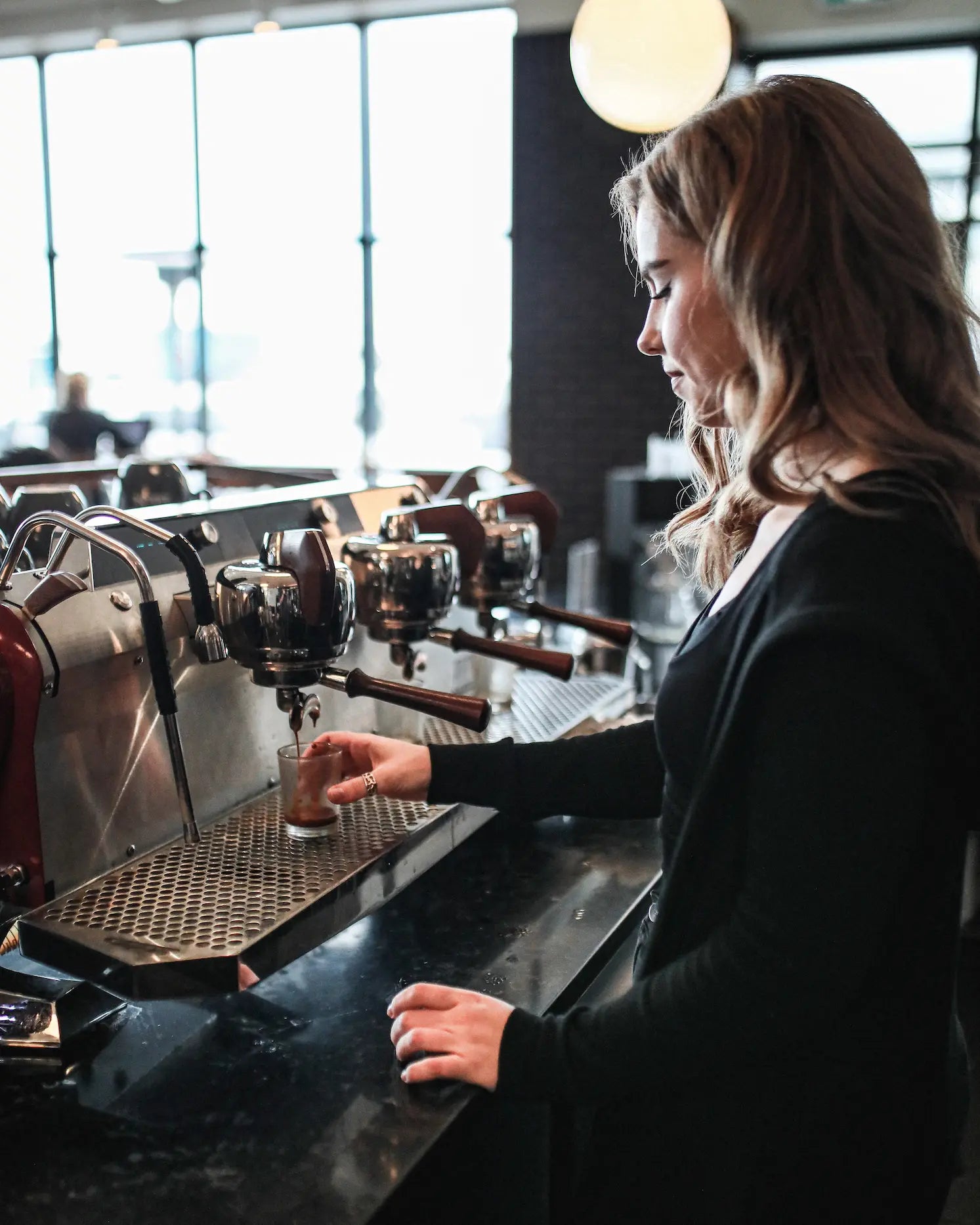 person pouring espresso