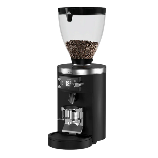 Black coffee grinder with clear container filled with coffee beans on a white background