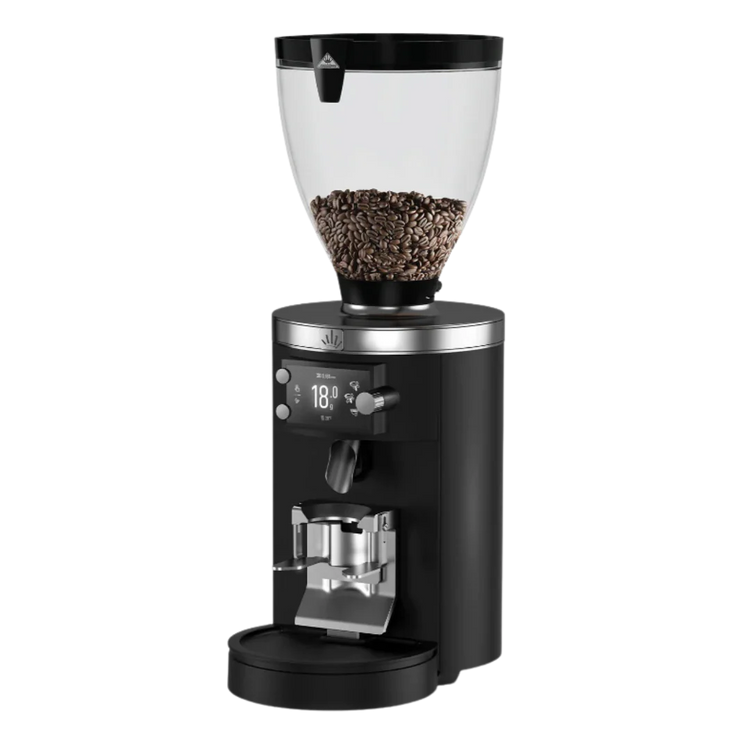 Black coffee grinder with clear container filled with coffee beans on a white background