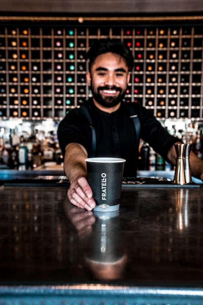 Happy chef serving coffee